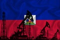 Developing Flag of haiti. Silhouette of drilling rigs and oil rigs on a flag background. Oil and gas industry. The concept of oil