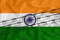 Developing India Flag, mesh fence and barbed wire. Concept of isolation of emigrants. With place for your text Royalty Free Stock Photo