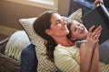 Developing a love for reading starts early. a mother and her daughter reading a book together on the sofa at home. Royalty Free Stock Photo