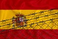 Developing Spain Flag, mesh fence and barbed wire. Concept of isolation of emigrants. With place for your text