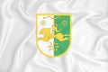 A developing white flag with the coat of arms of Abkhazia. Country symbol. Illustration. Original and simple coat of arms in