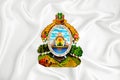 A developing white flag with the coat of arms of Honduras. Country symbol. Illustration. Original and simple coat of arms in