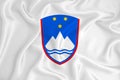 A developing white flag with the coat of arms of Slovenia. Country symbol. Illustration. Original and simple coat of arms in
