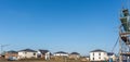 Development area with finished houses and houses still under construction with blue sky and copy space Royalty Free Stock Photo