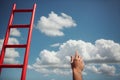 Development Attainment Motivation Career Growth Concept. Mans Hand Reaching For Red Ladder Leading To A Blue Sky Royalty Free Stock Photo