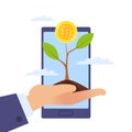 Development, growth of Bitcoin. Growing tree and hand with golden coin, smartphone background, successful investment in