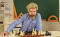 Development logics. School teacher. Playing chess. Intellectual hobby. Figures on wooden chess board. Chess is rarely Royalty Free Stock Photo