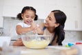 Development, mother and girl in kitchen, cooking and baking for learning, growth and being happy together at home. Mama Royalty Free Stock Photo