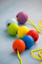 Developmental children`s toy. Colored wooden balls on a rope. Colorful wooden baby beads for necklace.