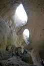 Devetashka cave in Bulgaria and visitors. Royalty Free Stock Photo