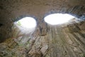 Devetashka cave in Bulgaria and visitors. Royalty Free Stock Photo