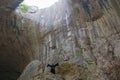 Devetashka cave in Bulgaria and visitors. Royalty Free Stock Photo