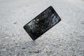 Broken, destroyed, ruined modern mobile smartphone, cell phone, mobile phone, phone. Broken, cracked screen and damages. Device Royalty Free Stock Photo