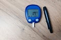 The device for measuring blood sugar lies on the table. Very low blood sugar (hypoglycemia). Copy space.