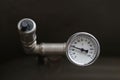 A device for measuring the temperature of water in the heating system. Pipe pressure relief valve. Royalty Free Stock Photo