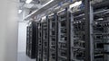 Device for mining crypto currency. Row of bitcoin miners set up on the wired shelfs. Mining cryptocurrency. Bitcoin farm