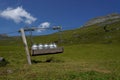 Device for transport of milk canisters with pulley. Agricultural technology on pastures in Alp mountains .