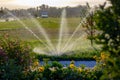 Devices for watering lawns in a city park Royalty Free Stock Photo