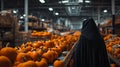 Devil in black cloak work with Pumpkins with halloween scary face on conveyor belt line.