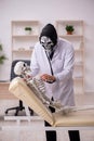 Devil doctor examining skeleton patient