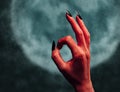 Devil hand with gesture OK at midnight Royalty Free Stock Photo