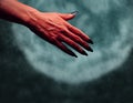 Devil hand with handshake gesture at midnight Royalty Free Stock Photo