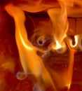 Devil`s face in a log fire