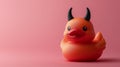 Devil-themed rubber duck on a pink background. Royalty Free Stock Photo
