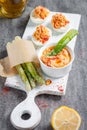 Deviled eggs appetizer with hummus. green asparagus Royalty Free Stock Photo