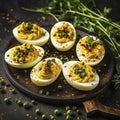 Deviled eggs with chives and parsley on a plate
