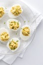 Deviled eggs on a decorative glass plate ready for sharing.