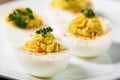 Deviled eggs garnished with parsley and paprika