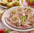 Deviled eggs, stuffed eggs filled with a paste made from smoked ham, mayonnaise, egg yolks and fresh chive on a plate. Royalty Free Stock Photo