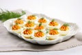 deviled eggs on a white rectangular platter