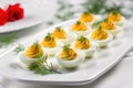 deviled eggs on a white rectangular platter