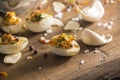 Deviled quail eggs arranged nicely on wooden table with decoration