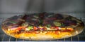 Devilled chicken spicy pizza inside an oven, homemade delicious bakery dinner. devilled chicken and bell pepper and tomatoes