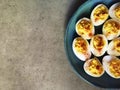 Devilled eggs on blue plate and grey background