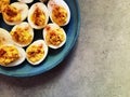 Devilled eggs on blue plate and grey background