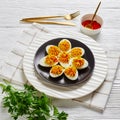 Devilled eggs with sriracha sauce on a black plate Royalty Free Stock Photo