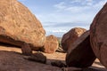 Devils Marbles are huge granite boulders scattered across a wide, shallow valley, 100 kilometers south of Tennant Creek, Australia