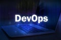 DevOps text on blue technology background with laptop. DevOps combines software development and IT operations Royalty Free Stock Photo