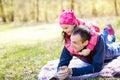 Devoted father and daughter lying on grass, enjoying each others company, bonding, playing, having fun in nature on a bright,