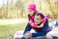 Devoted father and daughter lying on grass, enjoying each others company, bonding, playing, having fun in nature on a bright,