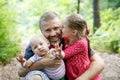 Devoted father hugging his son and daughter, enjoying the outdoor Royalty Free Stock Photo