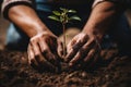 Devoted young gardener planting and watering plants for healthy growth in a lush garden