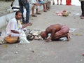 A devotee prays his priest during a religious ceremony