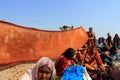 Devotees dry their clothes after the holy bath at Kumbh Mela