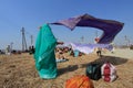 Devotees dry their clothes after the holy bath at Kumbh Mela