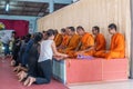 Devotees in front of Row of praying Buddhist monks on Ko Samui Island, Thailand
